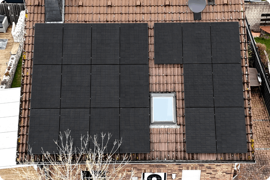 Vertically installed PV modules on a pitched roof, demonstrating effective drainage and alignment with roof lines for architectural integration.