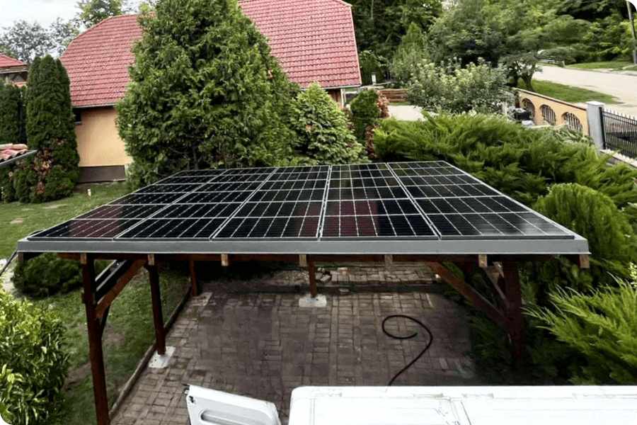 Bifacial PV modules installed on a garden carport roof, utilising ground reflection to enhance energy yield.
