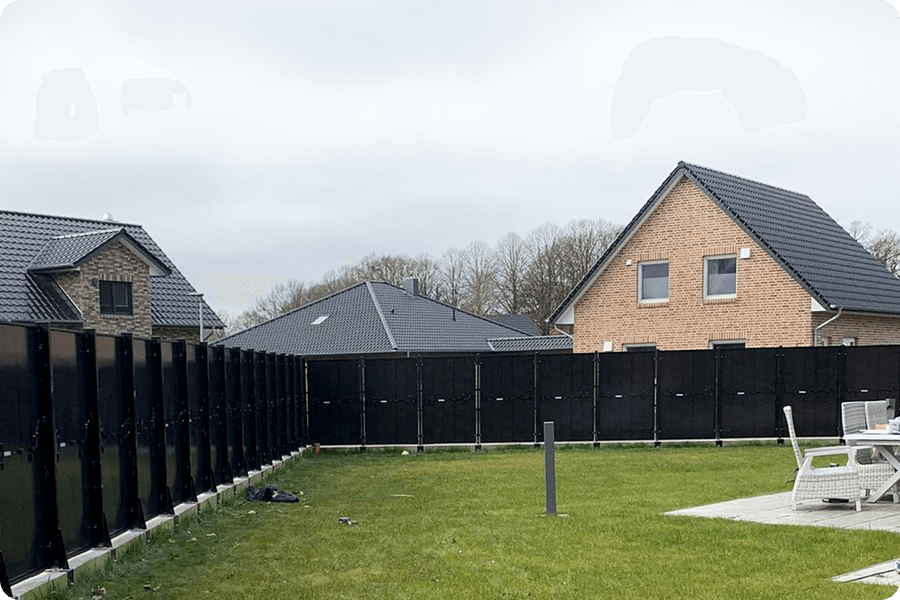 Lightweight bifacial or transparent-backsheet modules installed on a garden fence, enhancing rear-side generation through reflected light.