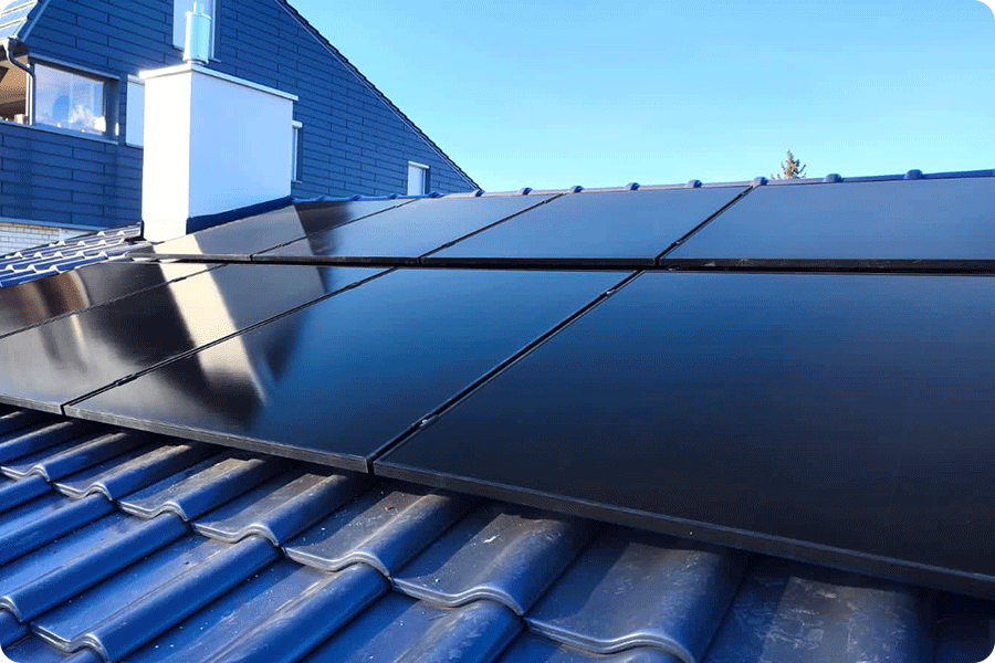 Full-black IBC modules on a European tiled roof, demonstrating seamless integration and clean array alignment.