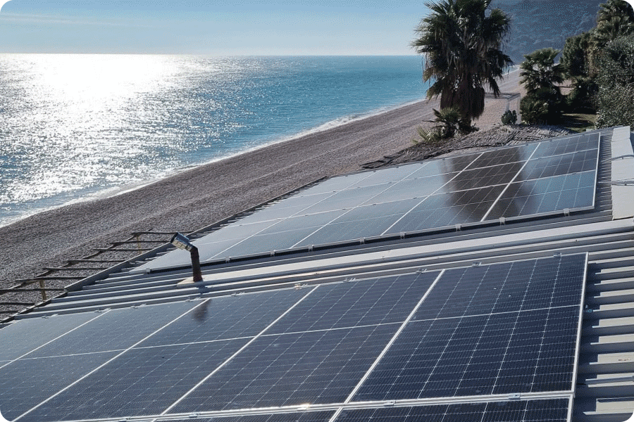 Rooftop solar system in a coastal area of Italy, illustrating the real-world application of double-glass solar panels in high-humidity and salt mist conditions.
