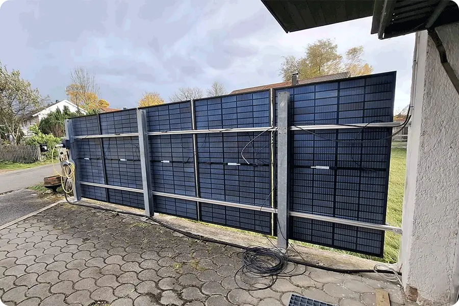 PV modules installed on a fence, showing a European residential solar application beyond the rooftop